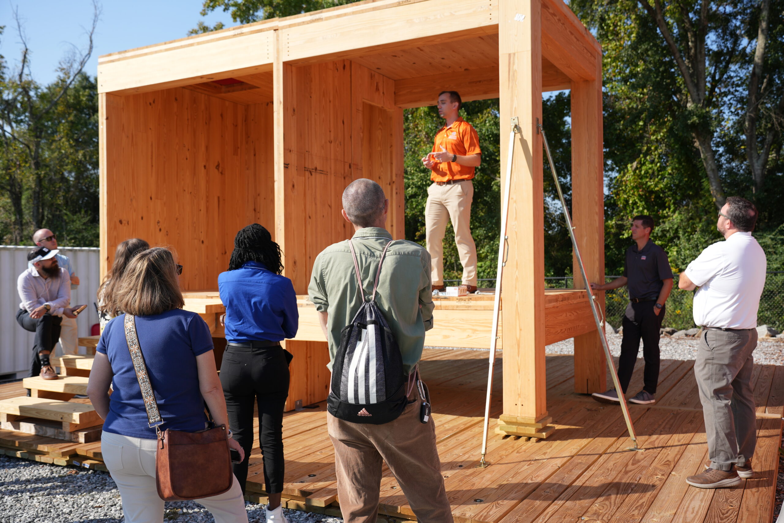 Auburn University professor stands in part of a mass timber building explaining the different ways CLT joints are formed during construction.